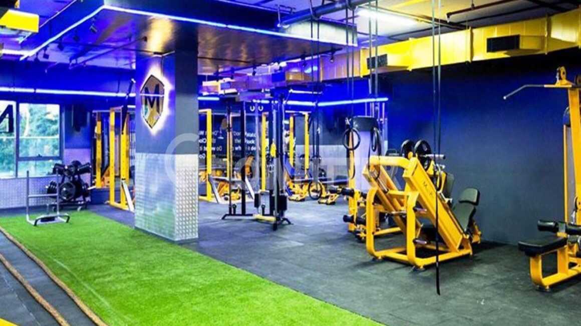 Functional training zone featuring tractor tires and MMA cages at a MultiFit gym branch