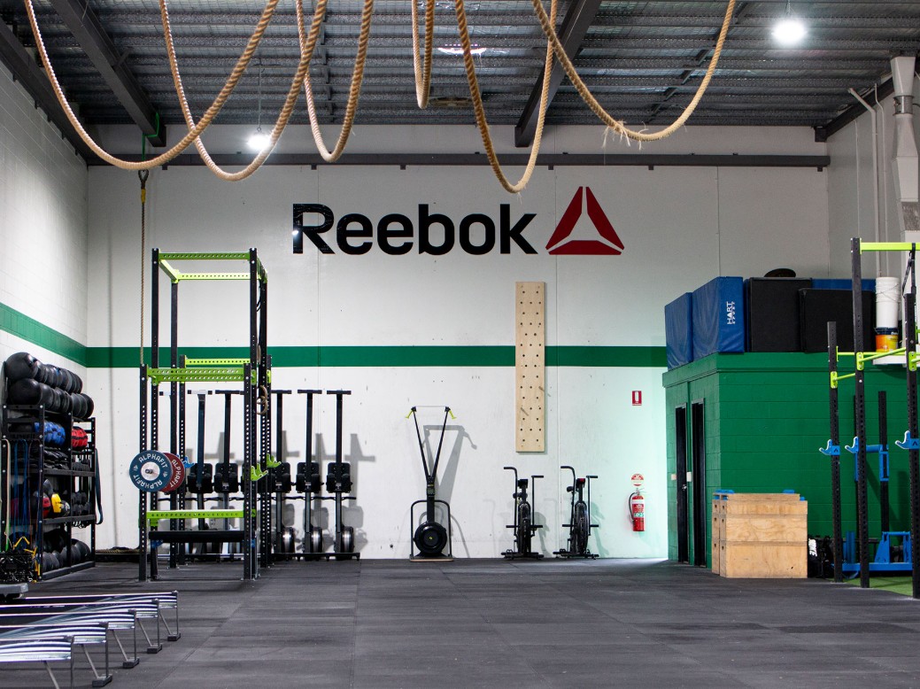 CrossFit box setup with pull-up bars and kettlebells for high-intensity functional training.