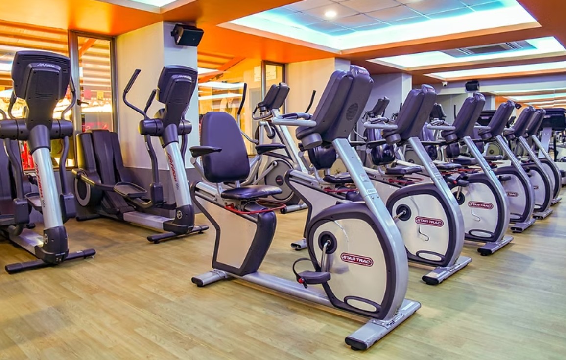 Multi-sport fitness complex in Pune featuring gym equipment and indoor sports courts.