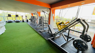 Gym interior with turf area, treadmills, and leg press machine