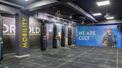 Signage for we are clut inside a clean, contemporary fitness facility.