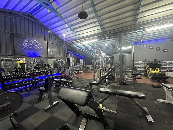 Still life of organized weight plates and barbells on storage racks.