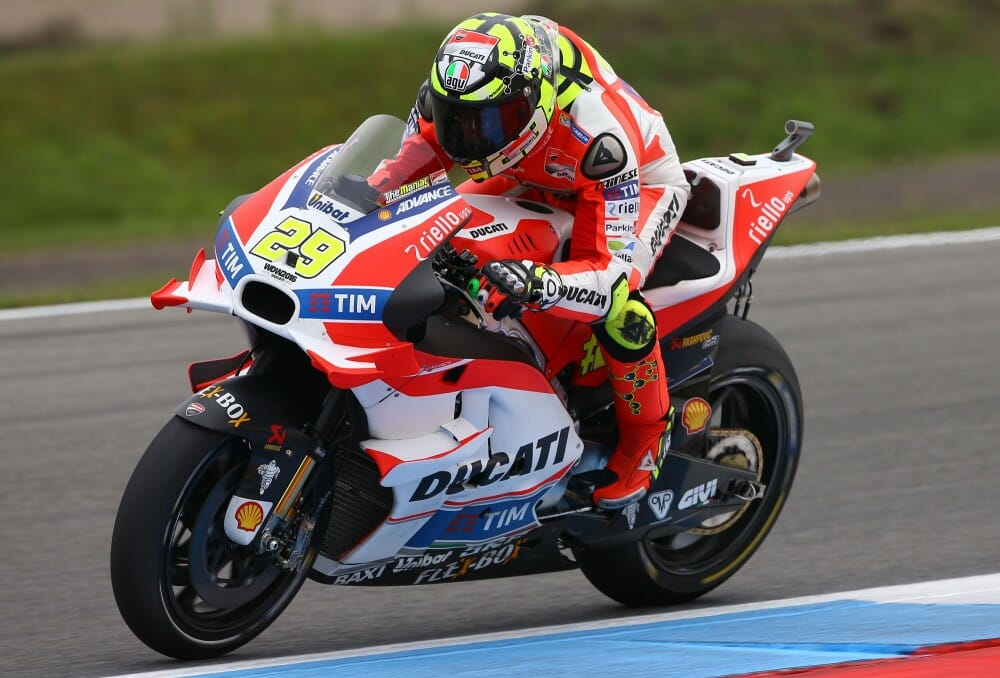 MotoGP racer leaning on a prototype Ducati, demonstrating the extreme costs behind one of the **most expensive sports** ever."